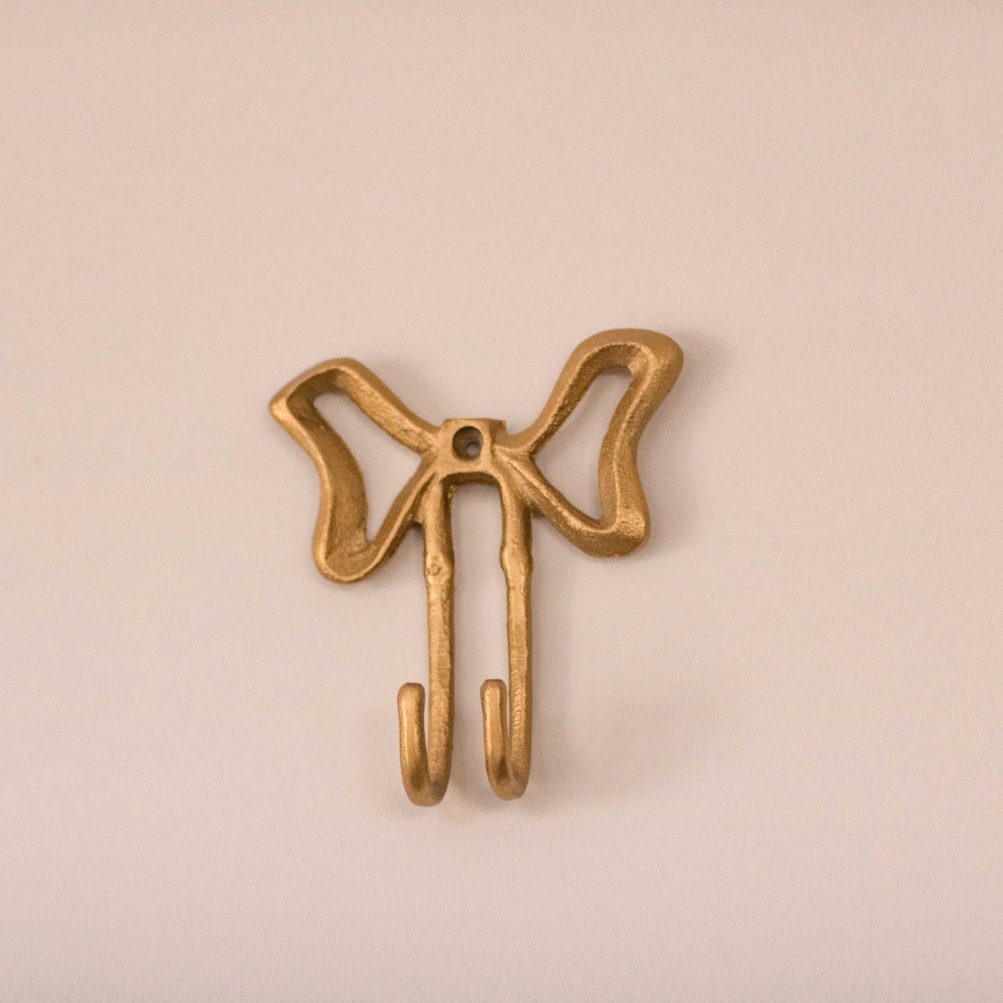 Shop our gold bow metal wall hook. A playful decorative hook for jewellery, bags, towels, hats and cute wall styling.