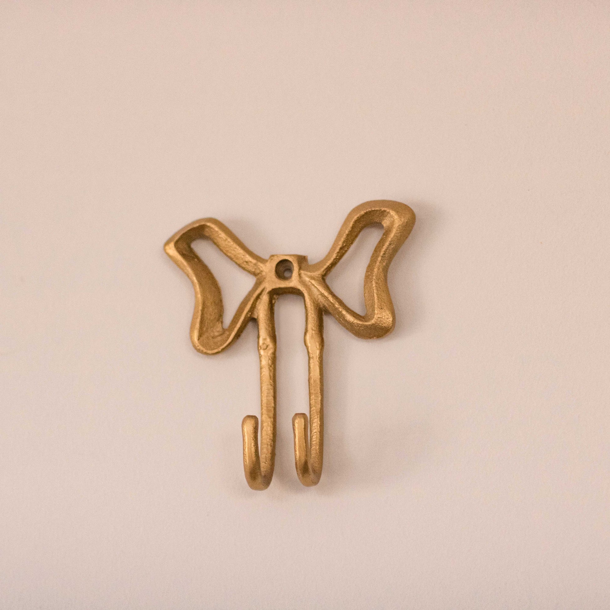 Shop our gold bow metal wall hook. A playful decorative hook for jewellery, bags, towels, hats and cute wall styling.