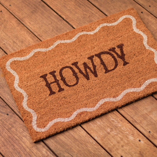 Shop our Howdy coir-style door mat with playful western lettering and wavy border. A fun welcome mat for entryways, porches and doorways.