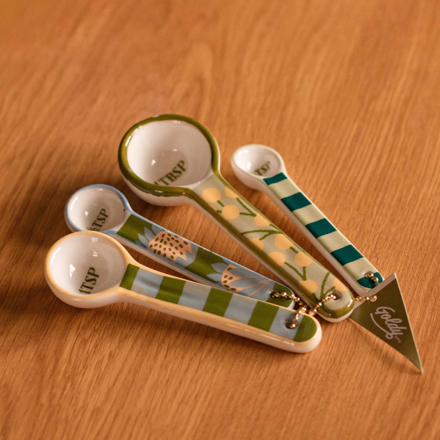 Shop our set of 4 ceramic measuring spoons with playful floral and stripe designs. Perfect for baking, cooking and colourful kitchen styling.