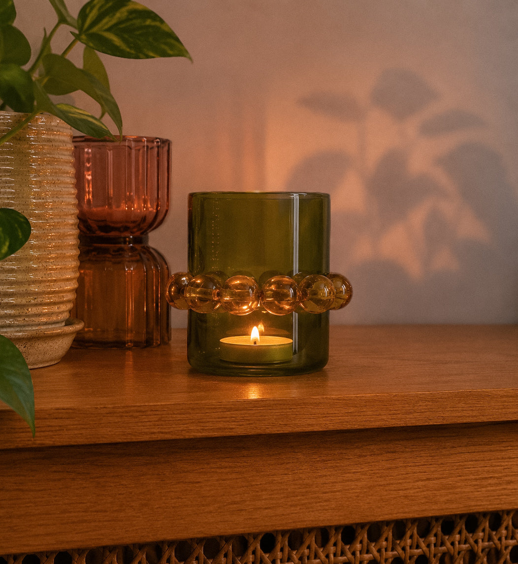 Shop our olive glass candle holder with dark beaded detail. A warm, retro home decor piece for shelves, tables and cosy styling.