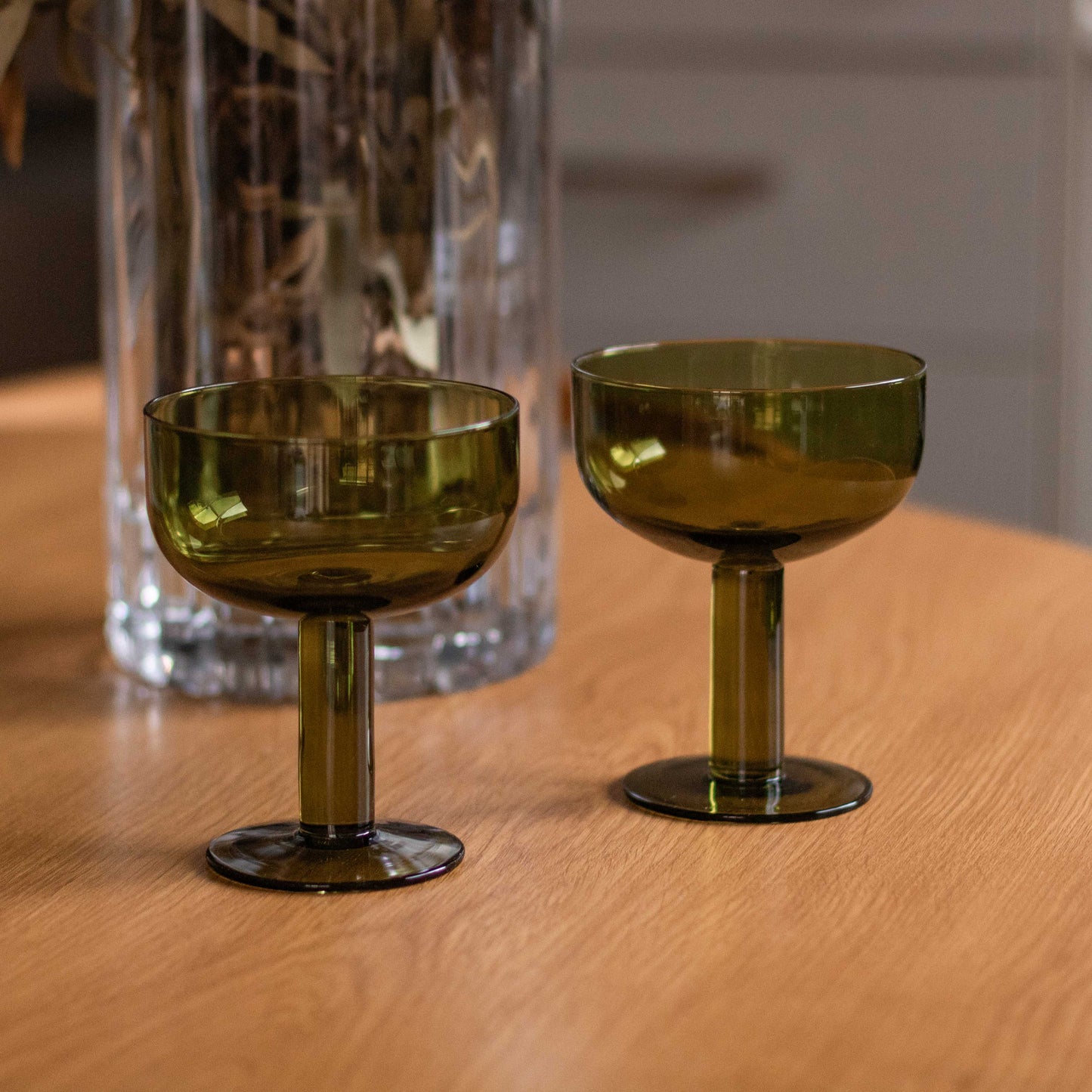 Shop our set of 2 olive green coupe glasses. Perfect for cocktails, champagne, spritzes, desserts and colourful table styling.
