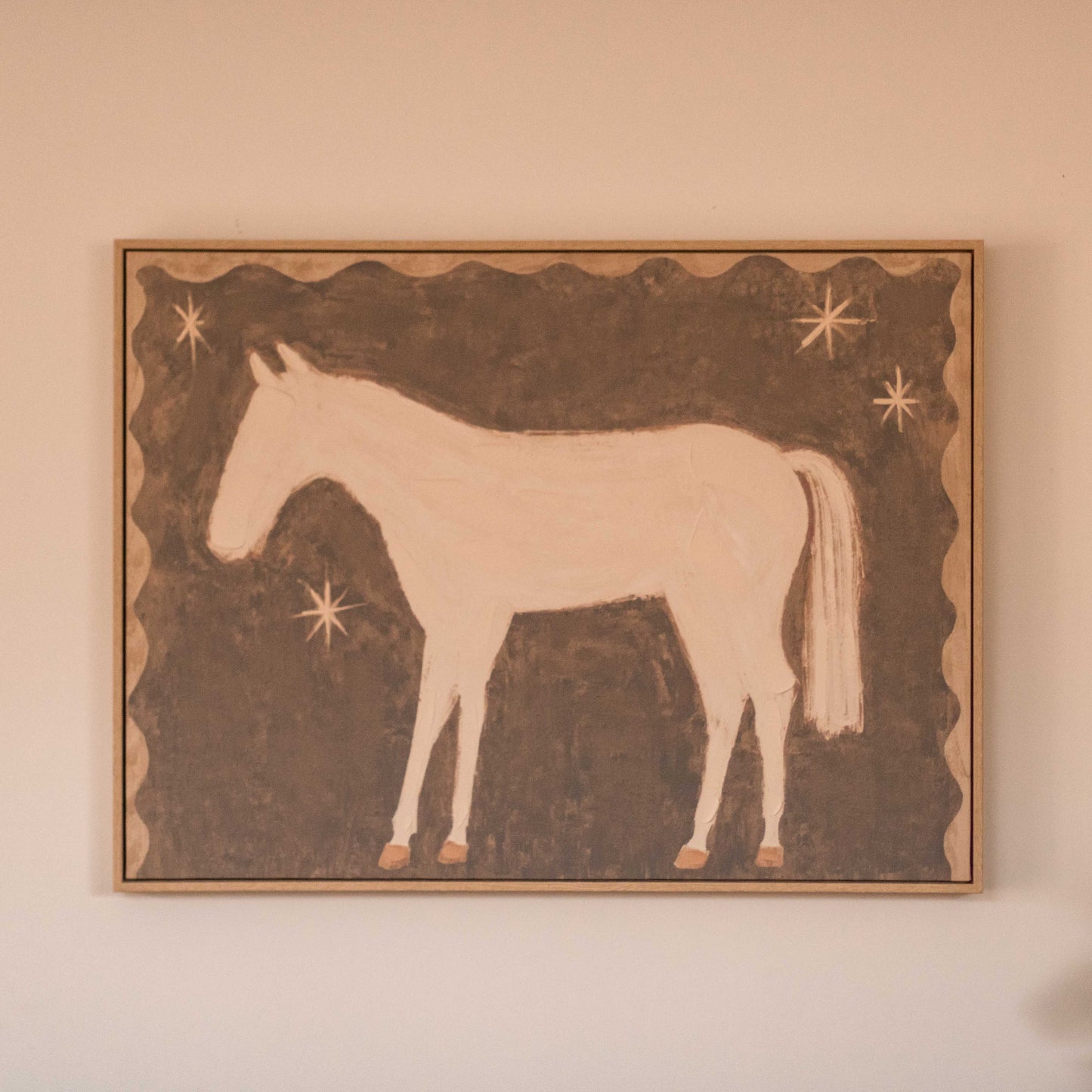 Featuring a soft white pony against a warm brown background with simple star details, this artwork has a sweet, nostalgic feel that adds character.