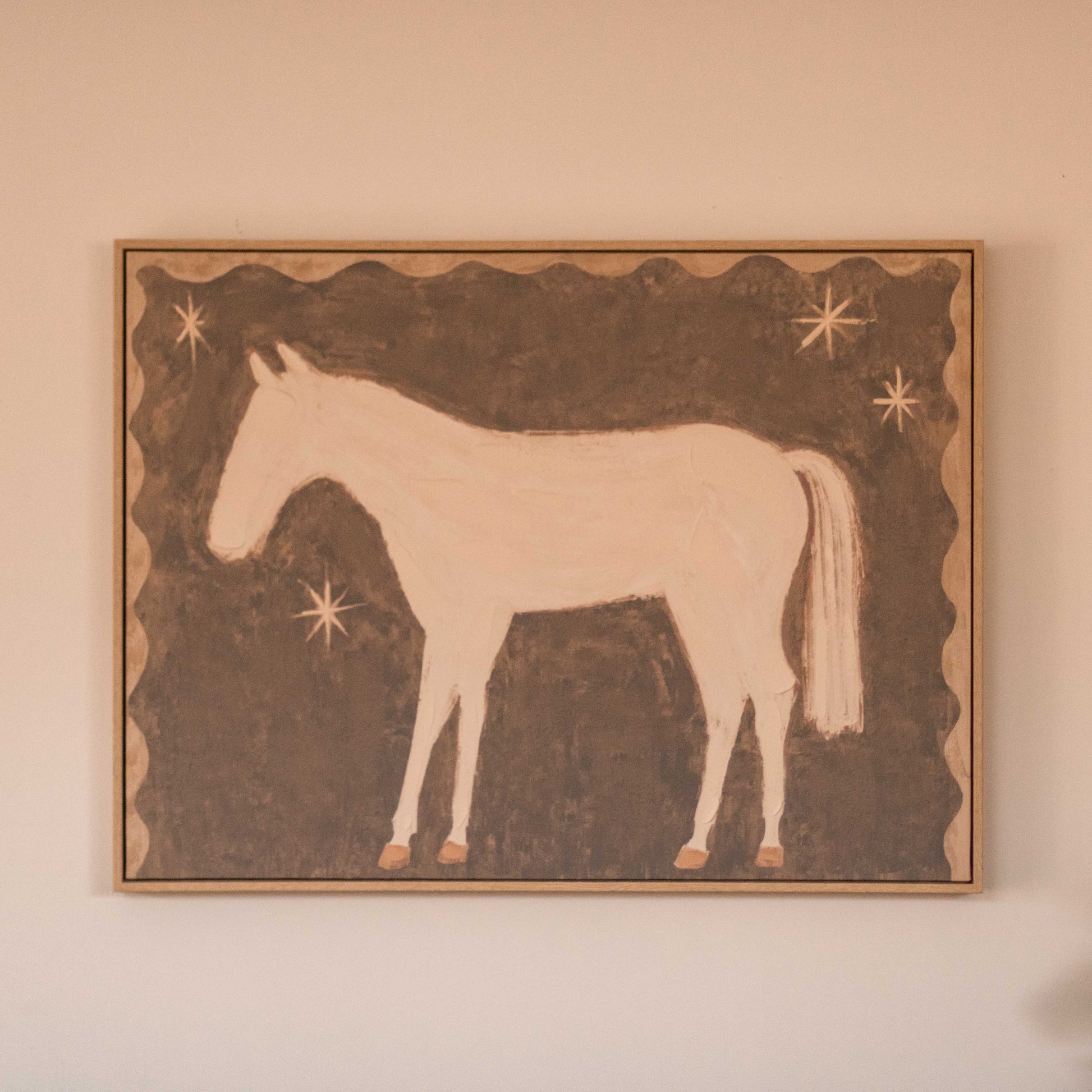 Featuring a soft white pony against a warm brown background with simple star details, this artwork has a sweet, nostalgic feel that adds character.