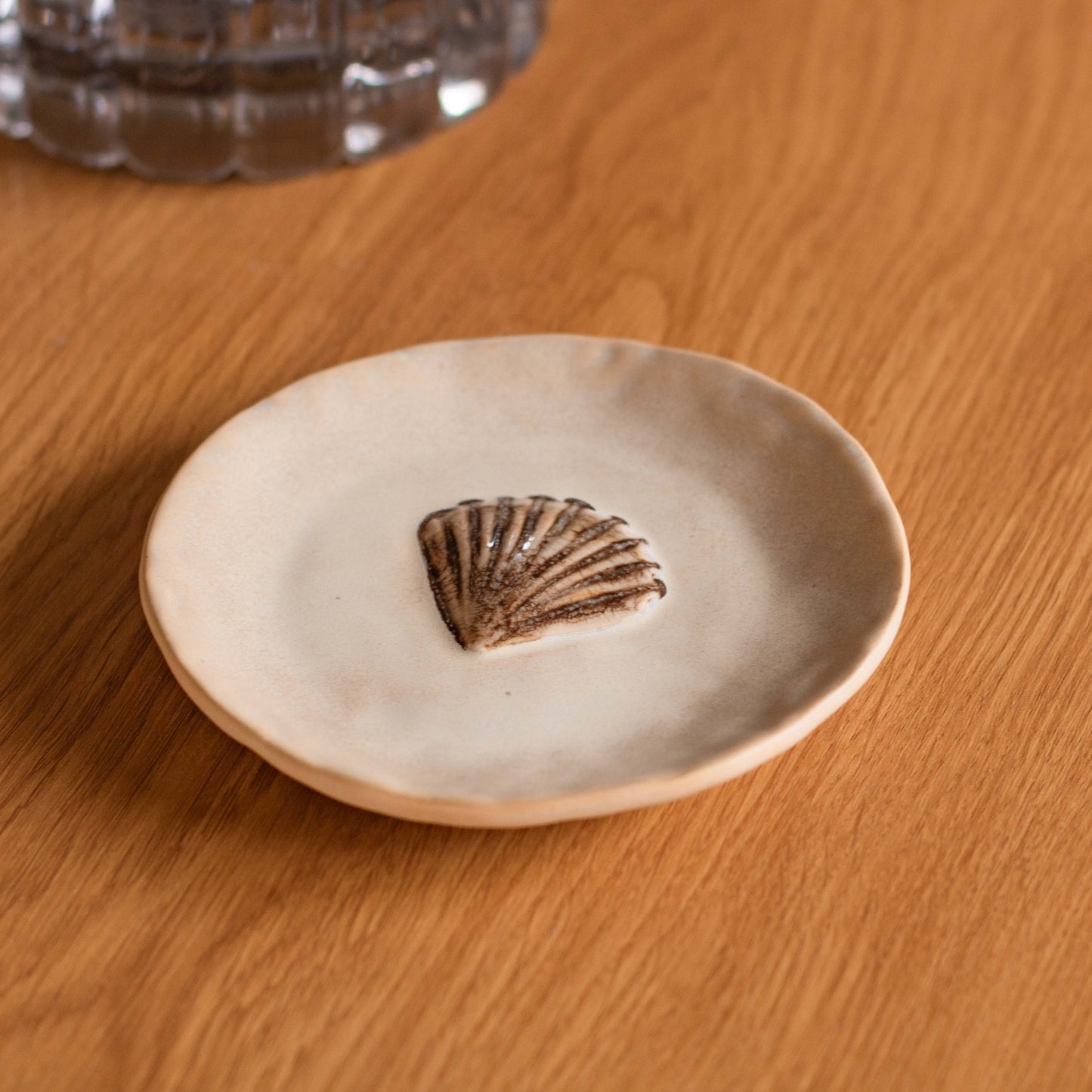 Shop our Riva ceramic shell plate with sandy brown glaze. Perfect for snacks, sweets, jewellery, coastal styling and table settings.